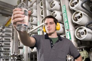 Water Technician Inspects Water at Public Utility Plant